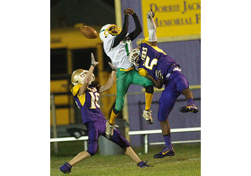 GARRET MEADE FILE PHOTO | Porters football players Connor Malone, left, and Gene Allen sandwiched Wyandanch’s Kamar Harris, who was unable to catch this pass in Thursday's game. 