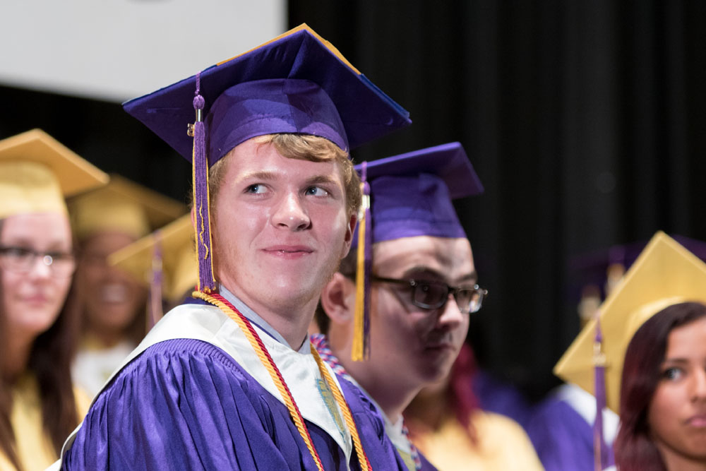 Valedictorian Connor Whittle listens to a speech during the ceremony.