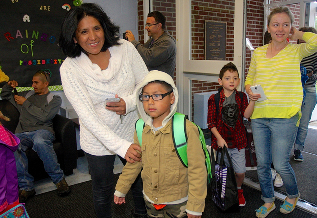 Janet Reninoso arrives with her son Christopher, 6, a kindergartner.
