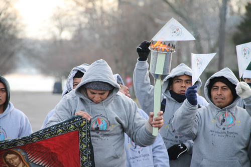 PAUL SQUIRE PHOTO | Worshippers prepare to run from Greenport to Riverhead in 2013 to deliver a holy flame honoring Our Lady of Guadalupe, a popular Hispanic religious symbol.