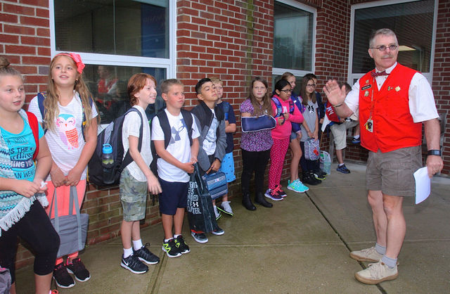 Fourth grade teacher Skip Munisteri, now in his 22nd year, gathers his class outsise so they can all go in together. "I start from the first day that we are a team- we all go in together."