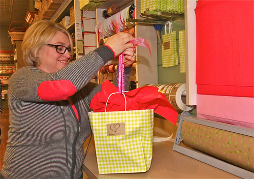 Jackie Wilsberg, Love Lane Sweet Shop owner, ties up a gift on Thursday. Barbaraellen Koch photo.
