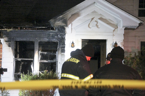 Officials with the Suffolk County Arson Squad begin their investigation of a fatal house fire in Greenport Wednesday night. (Credit: Paul Squire)