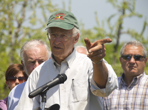 Cutchogue farmer Tom Wickham points to preserved land near his farm at a press conference Monday afternoon. Mr. Wickham said federal funds would allow farmers to upgrade to better practices cheaper. (Credit: Paul Squire)