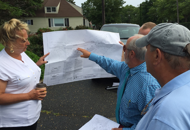 Greenport village administrator Paul Pallas points to the drainage swale plans. (Credit: Grant Parpan)