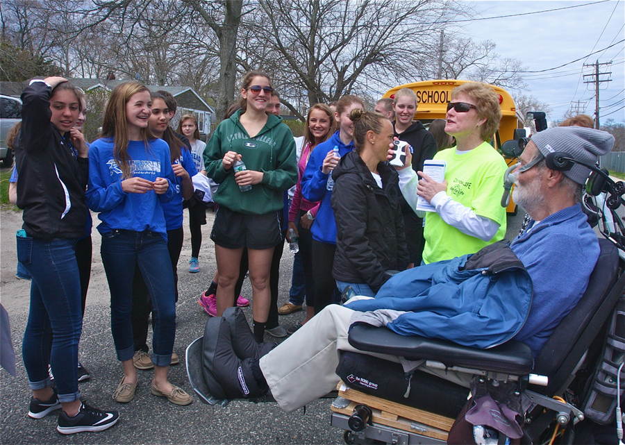 Event volunteer Barbara Brown of West Babylon talks to the Riverhead High School students who joined the walk to Town Hall.