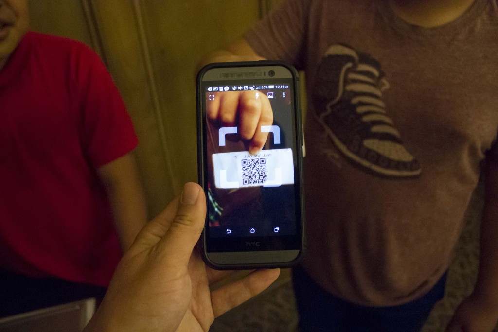 After scanning one of the codes with a QR reader app, a smartphone or tablet will automatically open a video made by the students. (Credit: Chris Lisinski)