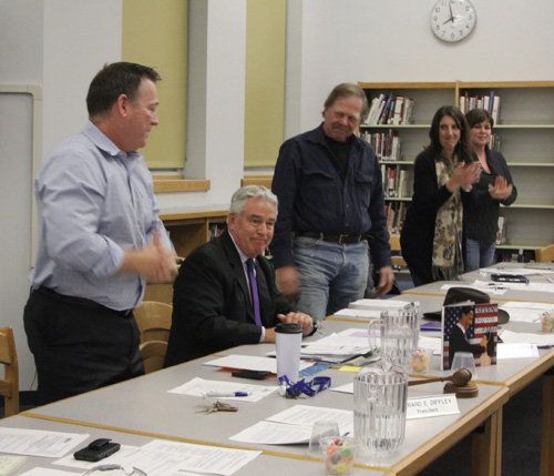 The Mattituck school board applauding Superintendent James McKenna moments after he announced his plans to retire. 