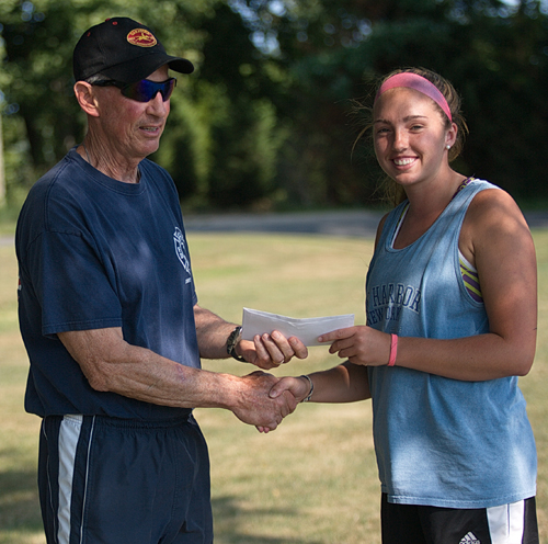 Tournament director Jim Christy presenting a scholarship to Molly Kowalski before the women's singles final on Friday. Declining player participation has brought an end to the 36-year tournament. (Credit: Garret Meade)