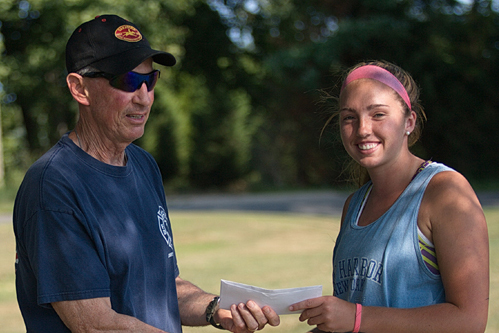 Tournament director Jim Christy presenting a scholarship to Molly Kowalski before the women's singles final of the Bob Wall Memorial Tennis Tournament. (Credit: Garret Meade)