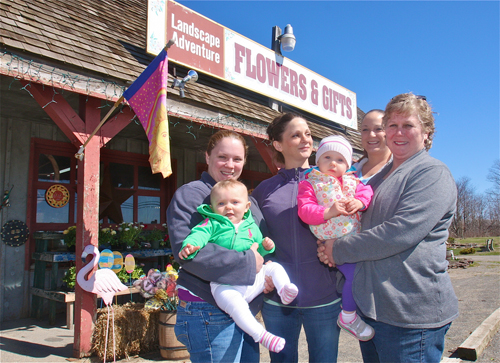 Jeanne Scott (far right) with her daughters and grandchildren (from left) Julie Murphy with daughter Sophie Murphy, 9 months, of Penn., Katie Scott Ryan of Riverhead, Rebecca Riccio of South Jamesprt, (Jeanne Scott) holding Dylan Ryan 15 months outside the business founded 37 years ago. (Credit: Barbaraellen Koch photos)