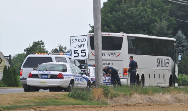 A bus is inspected along Route 48 in Cutchogue by officers from the Suffolk County and Southold Town police departments. (Credit: Grant Parpan)