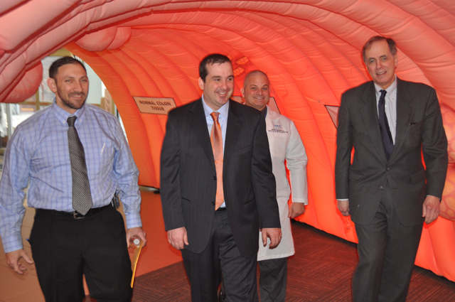 Caption: From left to right, Dr. Brett Ruffo, Dr. Mark Coronel, Dr. George Ruggiero and Dr. James Tomarken show the community what it’s like to walk through a 10-foot tall inflatable colon at Peconic Bay Medical Center. (Credit: PBMC)