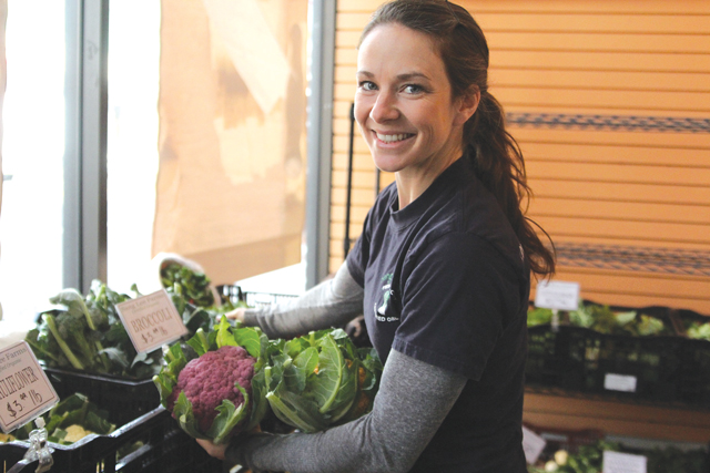 Ms. Senesac with Sang Lee Farms' purple and cheddar cauliflower at Riverhead's indoor farmers market last year. (Credit: Jen Nuzzo)