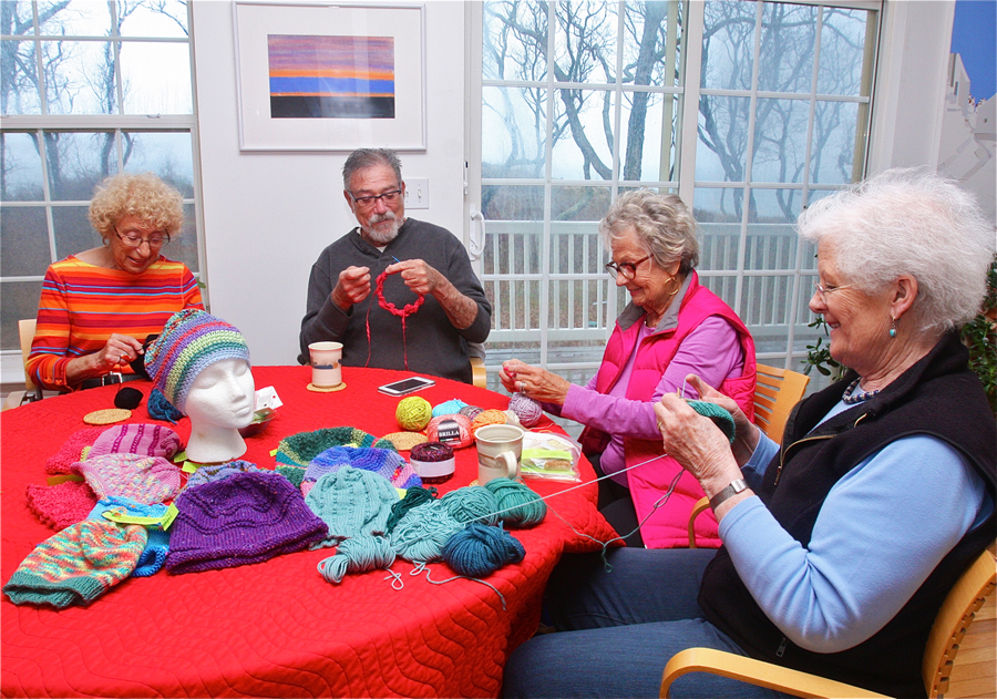 The Mad Hatters (from left) Sue Hanauer of Riverhead, Harold Gordon of Mattituck, Rita Cohen of Southold and Prue Brashich of Cutchogue during last week's bi-monthly knitting session at Ms. Hanover's kitchen table. (Credit: Barbaraellen Koch) 