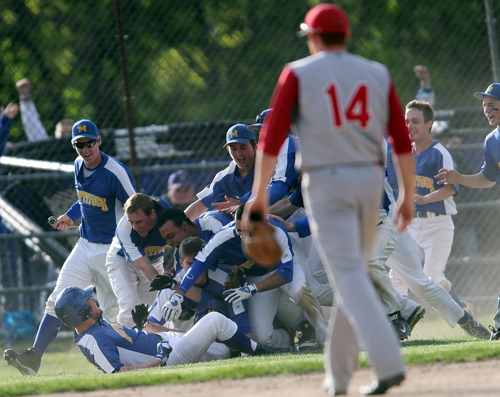 Mattituck players formed a jubilant dog pile after Chris Dwyer's walk-off hit capped a five-run rally in the seventh inning to defeat Center Moriches. (Credit: Garret Meade)