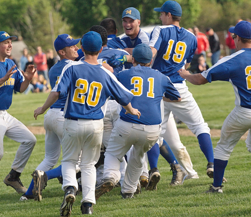 The Mattituck Tuckers meet on the infield grass for a postgame celebration after the team sealed its fourth county championship in 12 years. (Credit: Garret Meade)