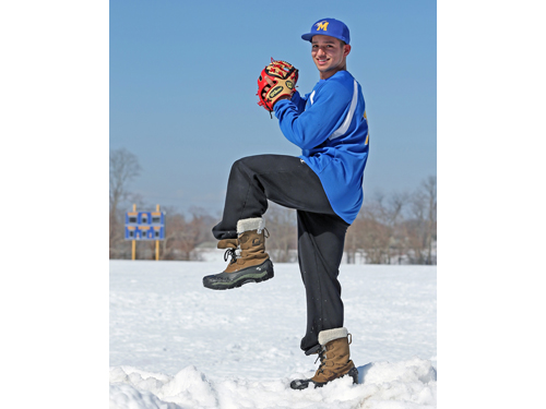 Marcos Perivolaris was perched atop a pile of snow, not a pitcher's mound, during Monday's practice. (Credit: Daniel De Mato)