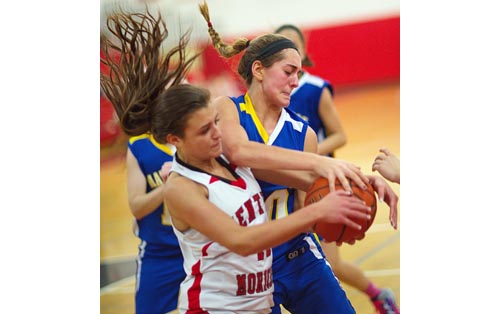Mattituck's Katie Hoeg, wrestling for the ball with a Center Moriches player last season, is an all-league forward heading into her fourth varsity season. (Credit: Garret Meade file)