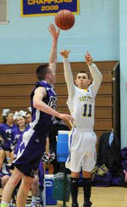 ROBERT O'ROURK PHOTO | Mattituck's Parker Tuthill, a sophomore guard making his first varsity start, popped a 3-point attempt over Port Jefferson's Harry Colucci.