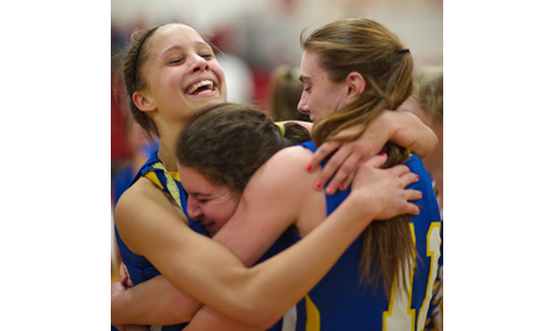 From left, Tiana Baker, Christine Bieber and Shannon Dwyer embrace each other following Mattituck's county semifinal victory over Center Moriches. (Garret Meade photo)