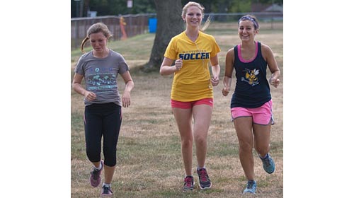 From left, Melanie Pfennig, Kaylee Bergen and Audrey Hoeg are among 10 returning runners for defending county champion Mattituck. (Credit: Garret Meade)