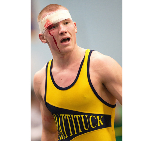 GARRET MEADE PHOTO | Tomasz Filipkowski of Mattituck/Greenport, who sustained a cut on his right eyebrow 10 seconds into the 170-pound final, went on to defeat Half Hollow Hills East's Maleik Henry, 4-3. Filipkowski was selected the tournament's most outstanding wrestler.