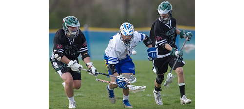 The chase is on for a ground ball. From left, Westhampton Beach's Evan Gagne, left, and Wyatt Sommer join Mattituck/Greenport/Southold's Dylan Marlborough in pursuit of the ball. (Credit: Garret Meade)