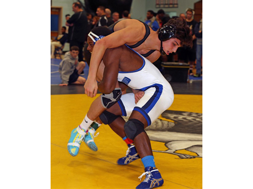 Mattituck/Greenport/Southold's Tanner Zagarino, right, wrestling against Riverhead's Raheem Brown, won the 170-pound title and was selected the North Fork Invitational's Champion of Champions. (Credit: Garret Meade)