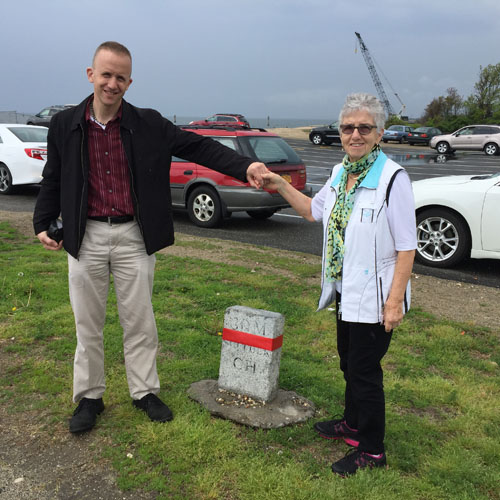 Derek Stadler and his mother, Hannelore, of Hicksville, pose next to Southold Town's 30th mile marker in Orient. (Rachel Young photos)