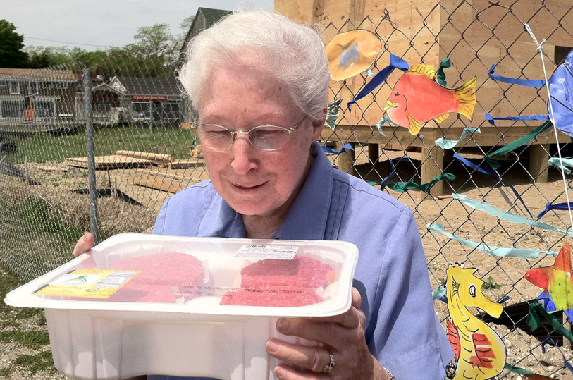 Sister Margaret Smyth and a pack of hamburgers she's going to help distribute to families in need. (Credit: Michael White)