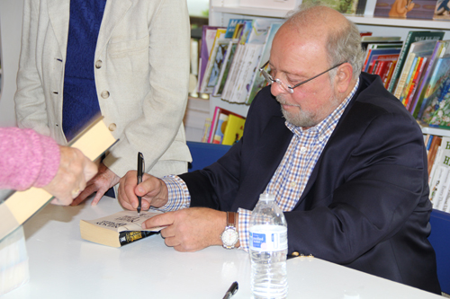 CARRIE MILLER PHOTO | Nelson DeMille signs a copy of his new book "The Quest" at BookHampton in Mattituck Saturday.