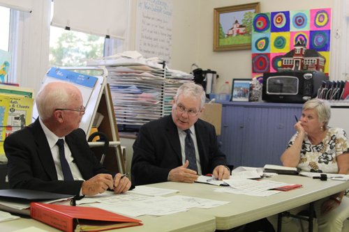 New Suffolk Elementary School principal tk, center, discussing the district's new policy of releasing public documents at Tuesday's meeting. (Credit: Jen Nuzzo)
