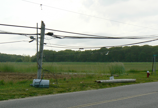 The scene Wednesday morning where a car crashed into a pole on New Suffolk Avenue. (Credit: Donald Kirby)