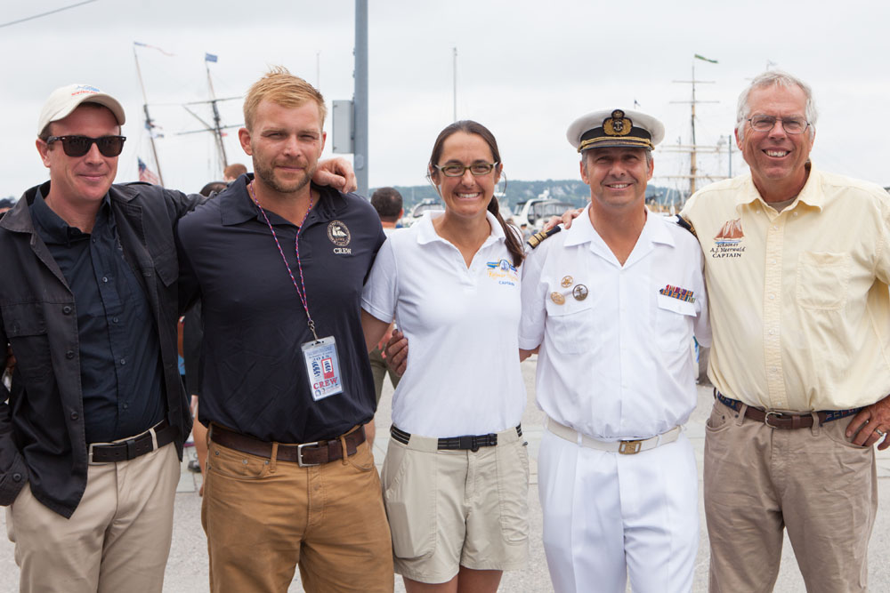 All five captains pose for a photo.  From left:  Sam Sikkema of the Picton Castle, Lynx Captain Jesse Doucette, Kalmar Nyckel Captain Lauren Morgens, Sagres Commanding Officer Paulo Portugal, and A.J. Meerwald Captain Jesse Briggs. (Credit: Katharine Schroeder)