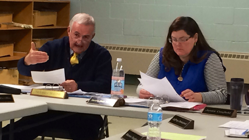 RACHEL YOUNG PHOTO | Oysterponds Superintendent Richard Malone, left, and school board president Dorothy-Dean Thomas, right, discuss the veterans tax exemption at Tuesday's school board meeting. 