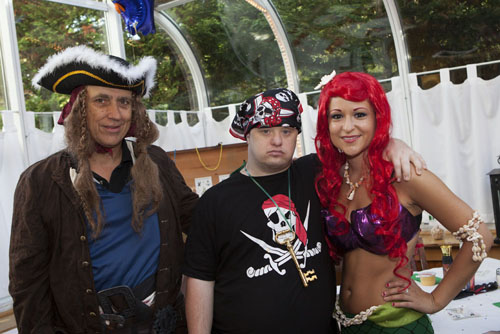 Pirate Warren Breuer, left, with guest of honor Paul Drum and mermaid Priscilla Kavanagh. (Credit: