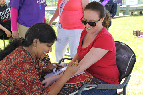 Eakta Gandhi of Riverhead giving Lisa Kholdi of Cutchogue a henna tattoo. 