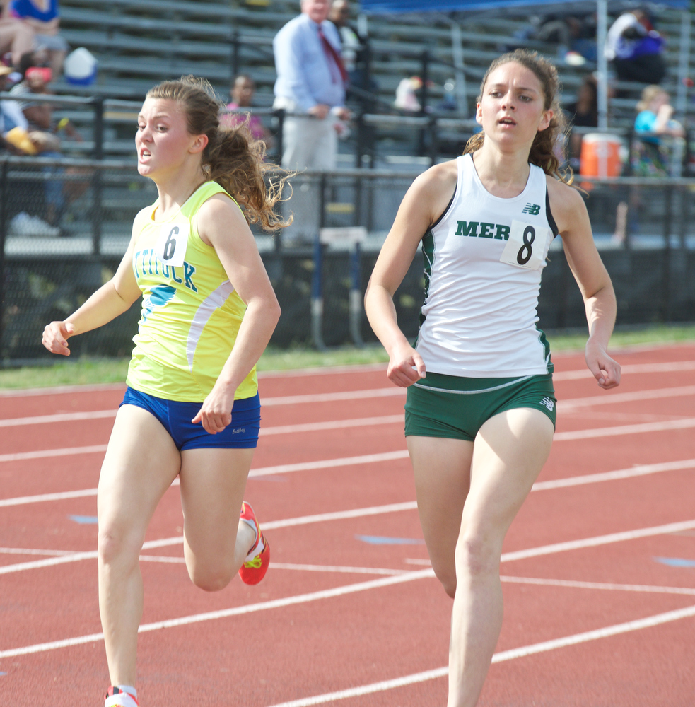 Melanie Pfennig (left) and Kaitlyn Butterfield cross in the 1,500.