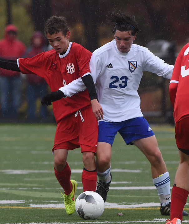 Mattituck midfielder Kevin Diffley vies for the ball with Jack Wicks. (Credit: Robert O'Rourk)