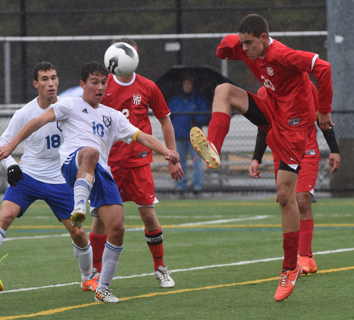 Mattituck's Paul Hayes and Matt Almond both try for the ball at midfield. (Credit: Robert O'Rourk)