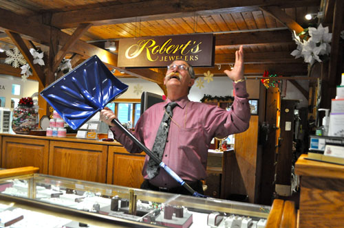 RACHEL YOUNG PHOTO | Robert’s Jewelers owner Robert Scott, snow shovel in hand, at his Southold store last Thursday morning. 