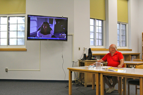School board member Jeff Smith talking with Sarah Hassildine via Skype. (Credit: Jennifer Gustavson)