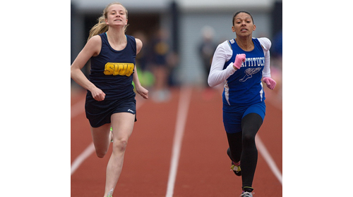 Shoreham-Wading River's Courtney Clasen, left, leaned forward at the finish line to nip Mattituck's Desirae Hubbard by 1/10th of a second in the 100 meters. (Credit: Garret Meade).