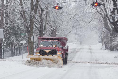 A plow makes its way down New Suffolk Road in Cutchogue Wednesday. Katharine Schroeder photo.