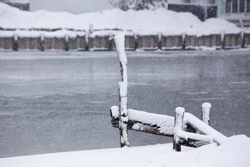 KATHARINE SCHROEDER PHOTO | Snowfall coats a dock in New Suffolk.