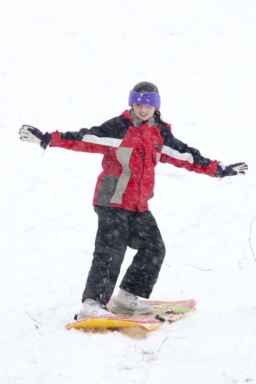 KATHARINE SCHROEDER PHOTO | Twelve-year-old Katie Parks of Cutchogue snow-surfs down the sledding hill in Mattituck.