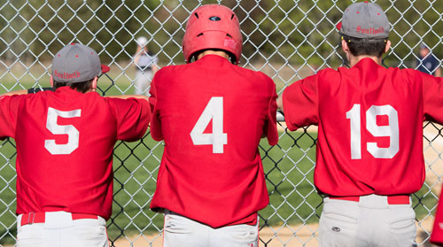 Southold's Sean Moran (5), Pat McFarland (4) and Noah Mina (19) get an up-close view of the game action Thursday when the First Settlers won the League IX championship outright. (Credit: Katharine Schroeder)