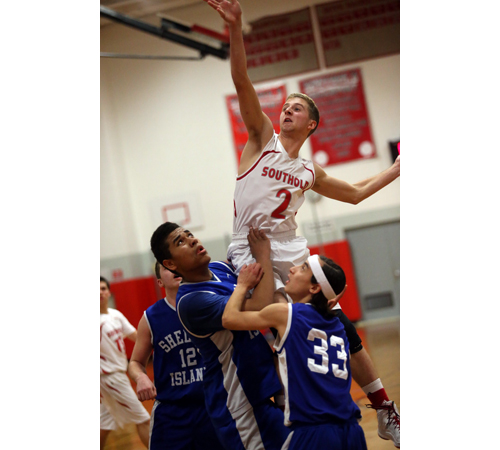 Southold's Shayne Johnson leans over Shelter Island's Semaj Lawrence and Peter Kropf (33). (Credit: Garret Meade)