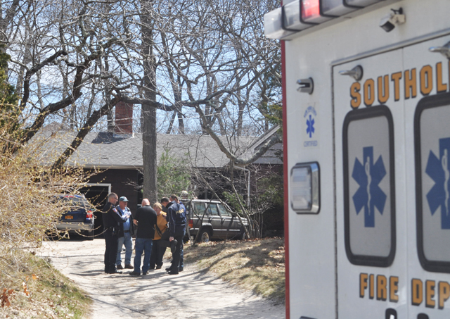 Southold fire chief Peggy Killian meets with Suffolk arson squad investigators as they arrive on the scene of a fatal house fire in Southold Wednesday. (Credit: Grant Parpan photos)